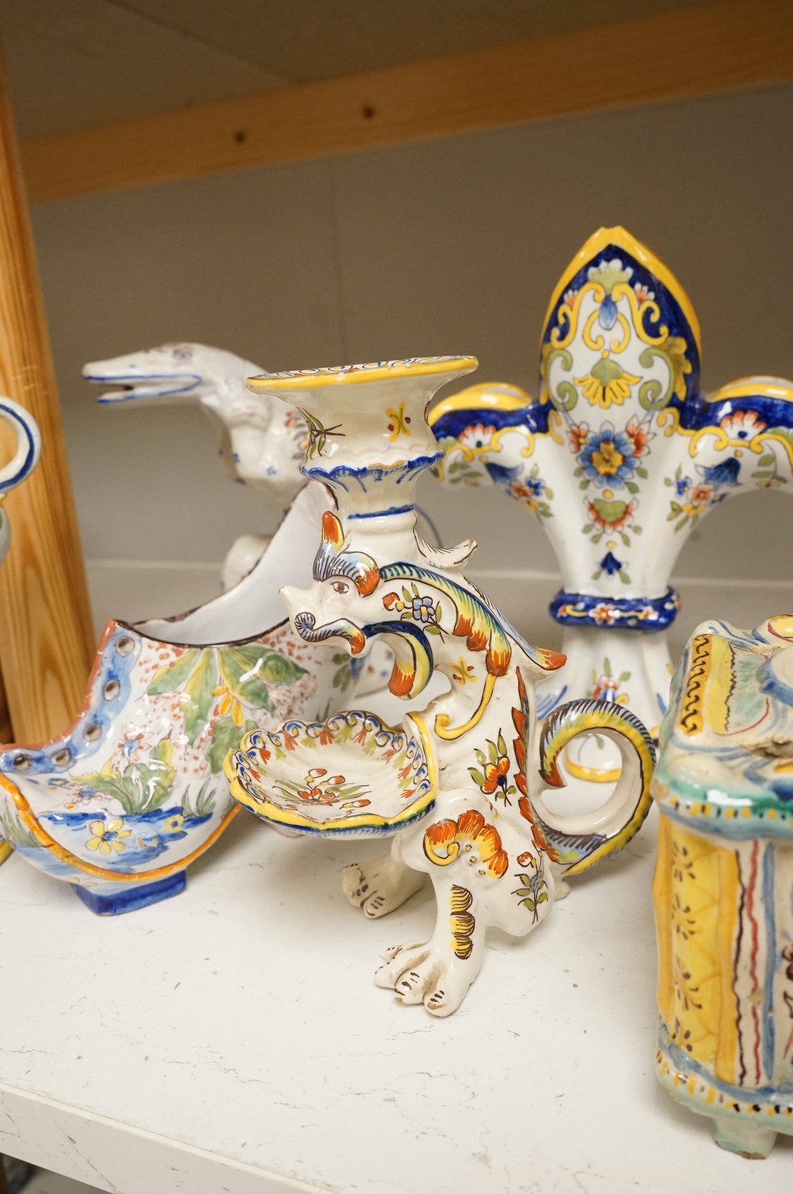 A group of French faience pottery to include spill vases, an ink well and dishes, largest 21cm high